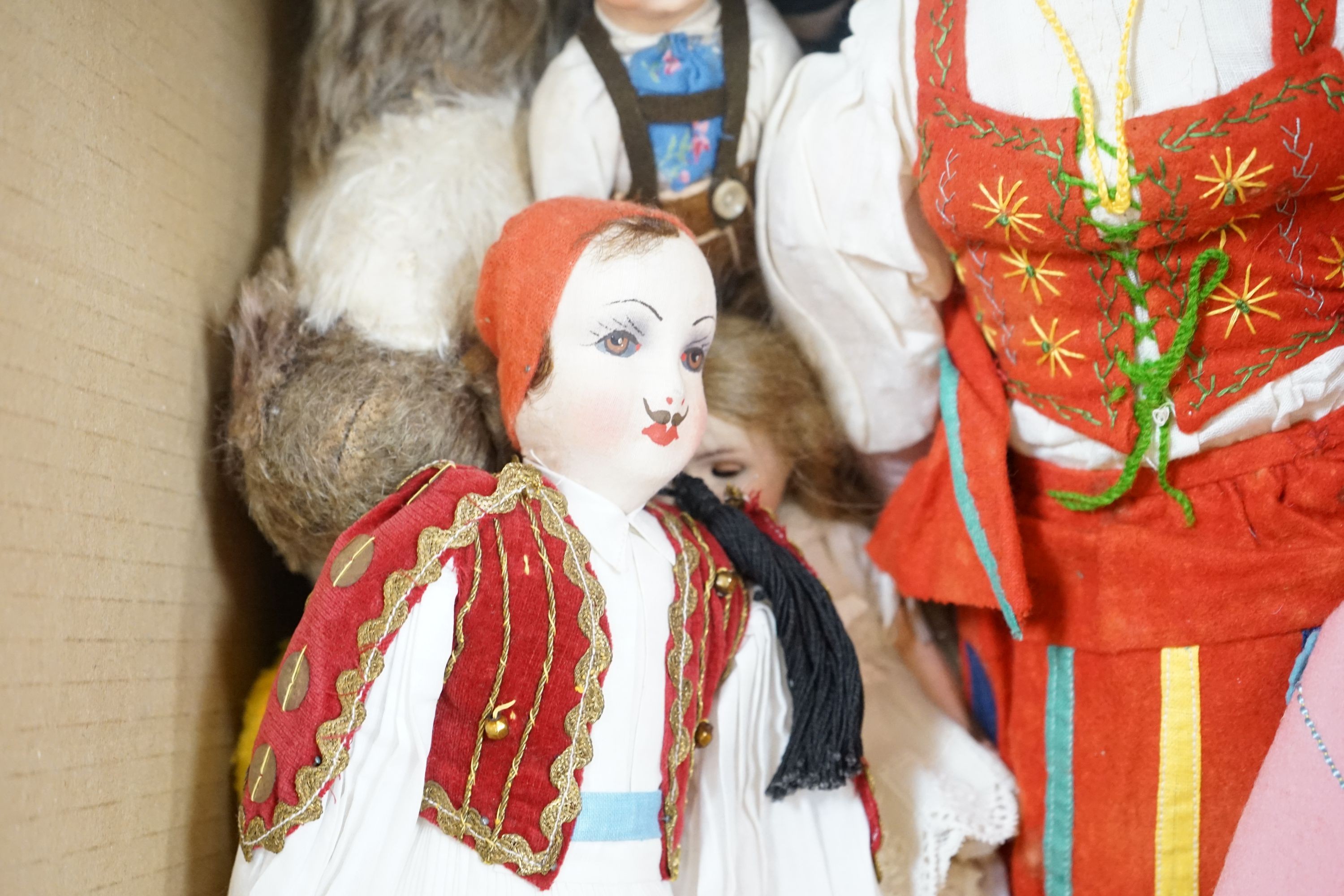 A collection of dolls and two soft toys